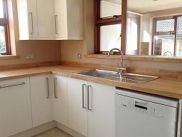 Logica White Gloss kitchen with oak worktops