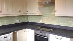 Optima T-bar Buttermilk kitchen fitted with laminate worktops